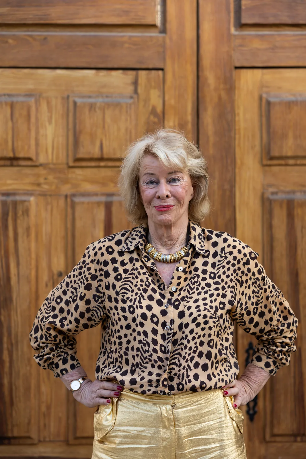 Jessica Larive met de handen in de zij voor een houten deur